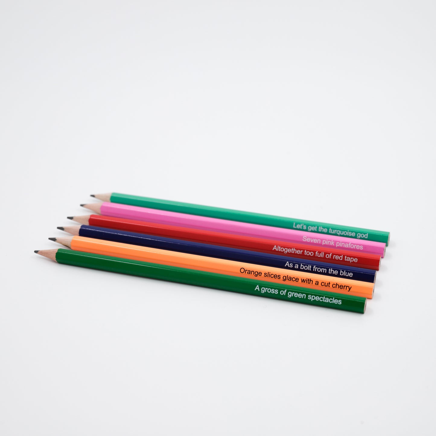 A set of six lead pencils with different colors and quotes labeled on each.